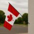 6 ft. black spinning flagpole mounted on a wall with a Canada flag
